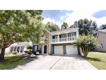 Charming two-story home featuring a balcony, a two-car garage, and well-maintained landscaping at 3157 Peartree Nw Dr, Acworth, GA 30101
