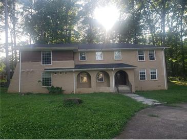 Spacious two-story home with a welcoming arched entryway, set in a beautiful wooded lot at 110 Chippewa Ct, Riverdale, GA 30296