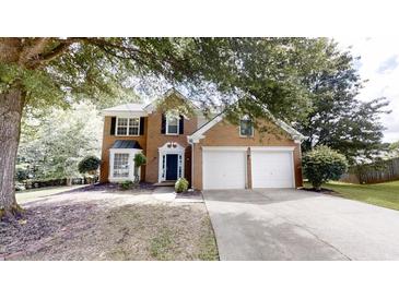 Two-story brick home with a manicured lawn and a two-car garage at 3001 Donamire Nw Ave, Kennesaw, GA 30144