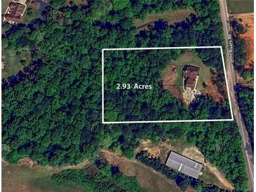 Beautiful 2.93 acre wooded lot with a traditional home with side-entry garage on John Rivers Rd in Dallas, GA at 6945 John Rivers Rd, Fairburn, GA 30213