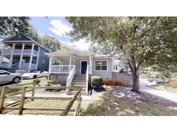 Charming home with inviting front porch, fresh paint, and well-manicured landscaping at 71 Thayer Se Ave, Atlanta, GA 30315