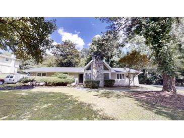 Charming single story home with mature trees, a stone chimney and a well manicured lawn at 366 O Brian Dr, Stone Mountain, GA 30088