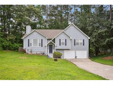 Charming two-story home featuring a well-manicured lawn and inviting curb appeal at 144 Boones Ridge Se Pkwy, Acworth, GA 30102