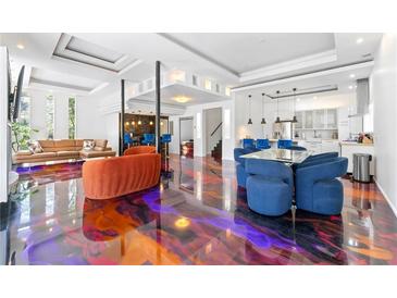 A spacious living room offers a sleek design with eye-catching floor, seating and open floorplan to kitchen and bar at 1231 Barnes Nw St, Atlanta, GA 30318