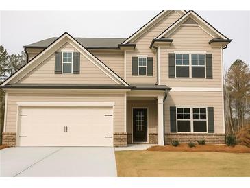 Charming two-story home with a two-car garage, neutral siding and dark shutters at 126 Jacobs Ln, Loganville, GA 30052