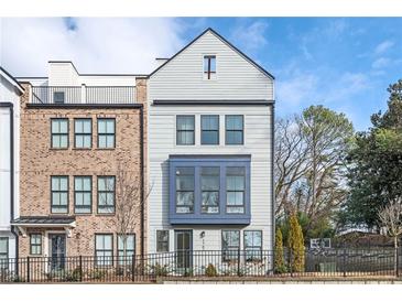 Charming multi-story townhouse with a combination of brick and light gray siding and fenced yard at 1762 Beckham Ne Pl, Atlanta, GA 30324