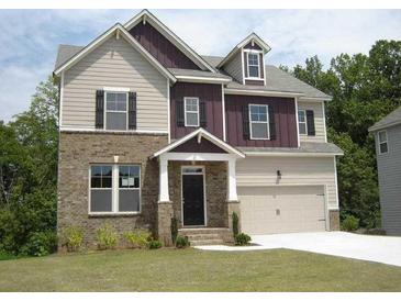 Charming two-story home with a brick and siding exterior, complemented by a well-manicured lawn at 4865 Fourth Rail Ln, Cumming, GA 30040