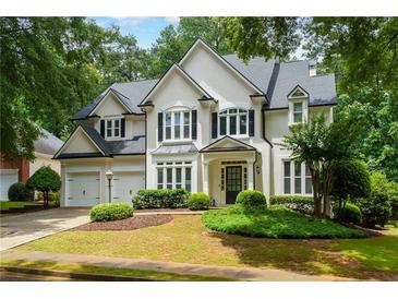 Charming traditional-style home with lush landscaping and a two-car garage at 2055 Beacon Hill Way, Alpharetta, GA 30005