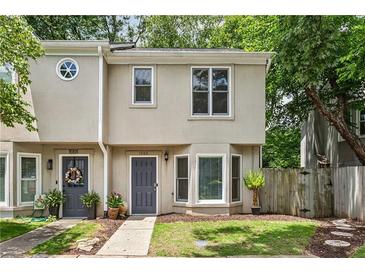Charming townhome with a well-manicured lawn and inviting front door at 1002 Defoors Nw Lndg, Atlanta, GA 30318