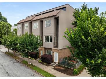 Attractive three-story townhome with a modern design and a combination of brick and gray stucco facade at 616 Angier Ne Ave # 4, Atlanta, GA 30308