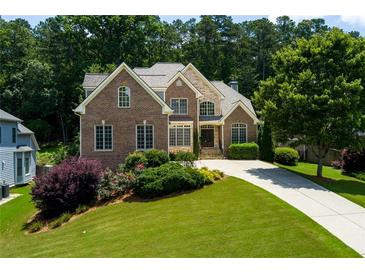 Beautiful two-story brick home with manicured lawn and mature trees in a desirable neighborhood at 650 Chestatee Creek Nw Dr, Acworth, GA 30101