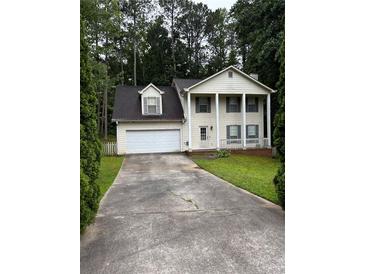 Charming two-story home with classic curb appeal, white garage door and pillar-supported porch at 2983 Trotters View Way, Snellville, GA 30039