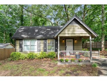 Charming cottage-style home with a cozy front porch and well-maintained landscaping at 778 Mclendon Dr, Decatur, GA 30079