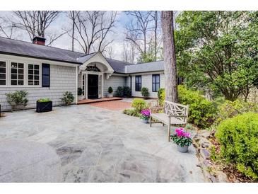 Charming home with a stone patio, lush landscaping, and a welcoming front entrance at 366 Blackland Nw Rd, Atlanta, GA 30342