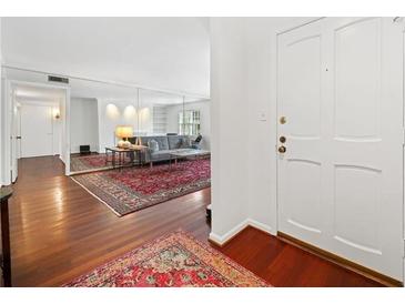 Bright living room with a decorative rug, comfortable sofa and natural light at 52 Chaumont Nw Sq, Atlanta, GA 30327
