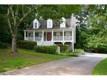 Charming home with a welcoming front porch and landscaped front yard at 55 Legend Creek Cv, Douglasville, GA 30134