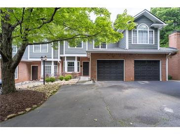 Charming townhome with brick accents, attached garages, well-kept landscaping and inviting curb appeal at 2680 Pine Tree Ne Rd # 2, Atlanta, GA 30324