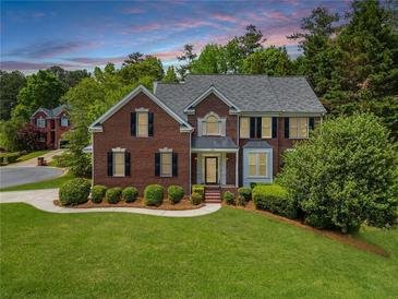 Charming two-story brick home with a well-manicured lawn and mature landscaping at 1552 Brentwood Dr, Marietta, GA 30062
