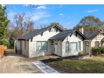 Charming home featuring a brick facade, black trim, and a landscaped yard with a new walkway at 2128 Hosea L Williams Ne Dr, Atlanta, GA 30317