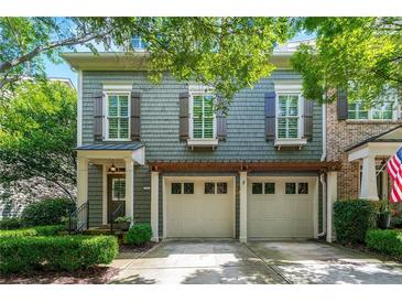 Charming two-story home features a two-car garage, complemented by lush greenery and a welcoming entrance at 2412 St Davids Sq # 16, Kennesaw, GA 30152