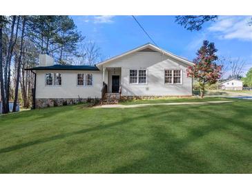 Charming home with a stone foundation, welcoming entrance, and well-maintained lawn at 374 Lamancha Ct, Lawrenceville, GA 30044
