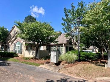 Charming single-story home with manicured lawn and mature trees, near the community mailbox at 302 Gladstone Dr, Mcdonough, GA 30253