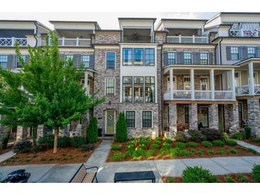 Charming townhome with brick facade, lush landscaping, and inviting front entrance at 414 Concord St, Alpharetta, GA 30009