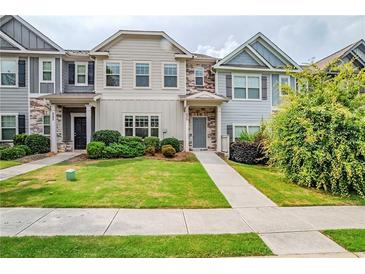 Charming townhomes featuring manicured lawns and welcoming entrances at 235 Orchard Dr, Covington, GA 30014