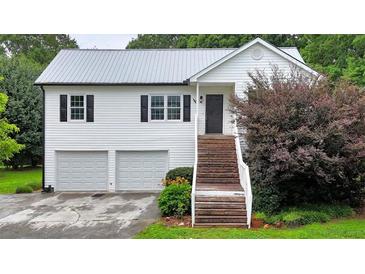 Charming two-story home with white siding, black shutters, and a welcoming staircase at 33 Moriah Ne Way, Rydal, GA 30171