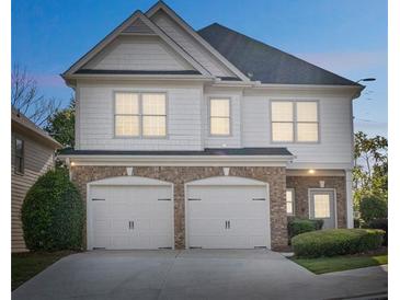 Charming two-story home featuring a two-car garage, complemented by lush landscaping at 296 Water Oak Pl, Alpharetta, GA 30009