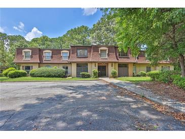 Inviting condo complex with mature trees, manicured landscaping, and ample parking at 2972 Parc Lorraine, Lithonia, GA 30038
