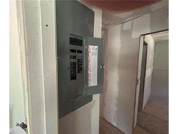 Image shows an electrical panel with open door on a wall; electrical components visible at 4601 Wilson James Rd, Atlanta, GA 30331