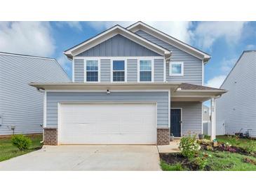 Charming two-story home with a two car garage and a well-maintained front yard at 109 Paulownia Cir, Mcdonough, GA 30253