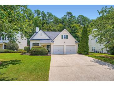 Charming traditional home featuring a well-manicured lawn and a two-car garage at 181 Weatherstone Dr, Woodstock, GA 30188