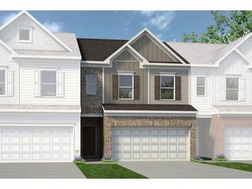 New construction townhome featuring a brick and siding exterior with attached two-car garage at 18 Jacobs Farm Ln # 9, Lawrenceville, GA 30045