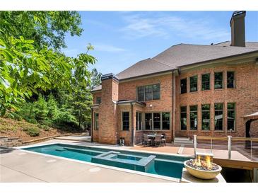 Stunning backyard with pool, spa, fire pit and large deck for entertaining with lots of privacy at 908 Basingstoke Ct, Suwanee, GA 30024