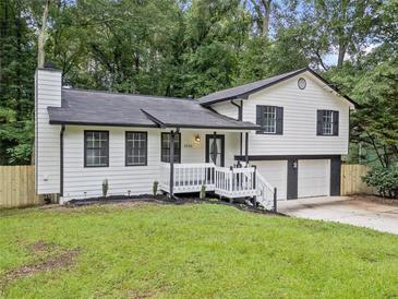 Charming home featuring fresh white siding, a black roof, and well-manicured landscaping at 3232 Valley View St, Powder Springs, GA 30127