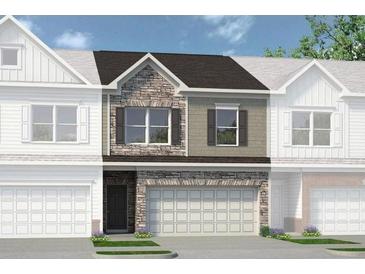 Beautiful townhouse with stone and siding exterior, a garage, and manicured landscaping at 100 Jacobs Farm Ln # 39, Lawrenceville, GA 30045