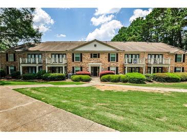 Charming brick building with balconies and manicured landscaping offers inviting curb appeal at 3650 Ashford Dunwoody Ne Rd # 514, Atlanta, GA 30319