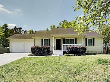Charming single-story home featuring a well-maintained front yard and an attached two-car garage at 365 Wesley Mill Pl, Villa Rica, GA 30180