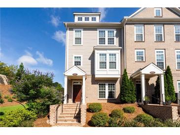 Charming townhome featuring a brick facade, well-maintained landscaping, and an inviting front entrance at 621 Hanlon Way, Alpharetta, GA 30009
