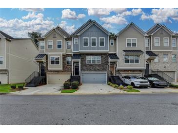 Charming townhome exteriors feature varied colors, stone accents, garages, and landscaped entryways at 2719 Hedgeway Cir, Kennesaw, GA 30144