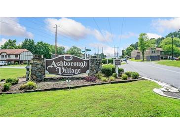 Ashborough Village Condominiums sign with stone base and manicured lawn welcomes residents and guests at 1810 Ashborough Se Rd # G, Marietta, GA 30067