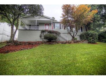 Charming single-Gathering home with a cozy front porch and a beautifully landscaped yard at 2002 Shalimar Ne Dr, Atlanta, GA 30345