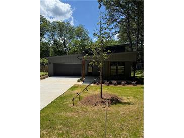 Charming single-story home with a modern design, well-manicured lawn, and ample curb appeal at 2588 Abner Nw Pl, Atlanta, GA 30318