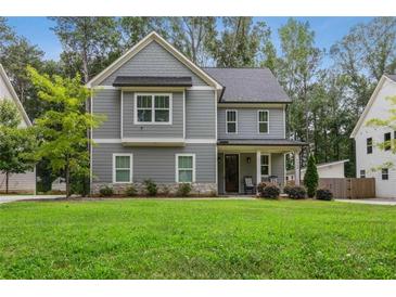 Charming two-story home with gray siding, a manicured lawn, and a welcoming front porch at 2362 Browns Mill Rd, Atlanta, GA 30315