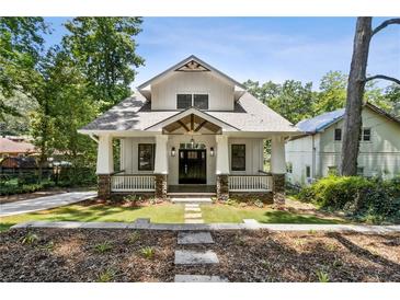 Charming craftsman home featuring a welcoming front porch, stone accents and a well-manicured lawn at 4642 Orchid Dr, Pine Lake, GA 30072