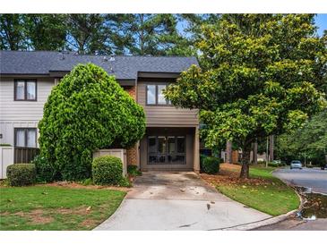 Charming townhome with mature trees, neutral siding, and driveway, offering a welcoming curb appeal at 2471 Cedar W Brk, Marietta, GA 30067