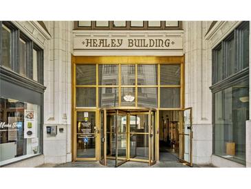 Elegant building entrance with a gold revolving door and the words 'Healey Building' above at 57 Forsyth Nw St # 16G, Atlanta, GA 30303