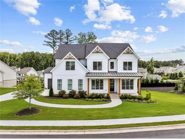Beautiful two-story white home with a landscaped yard, complemented by a charming walkway to the front door at 6080 Simone St, Acworth, GA 30101